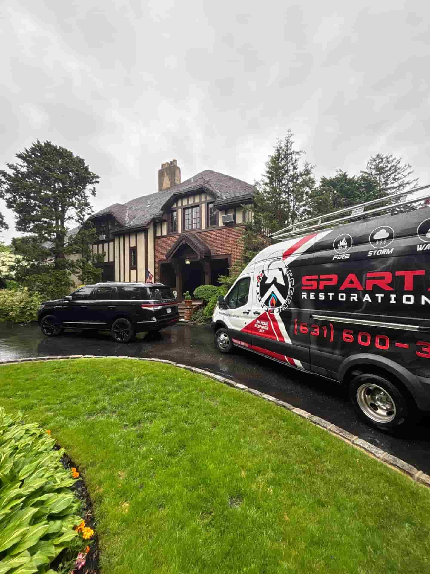 Fire damage restoration crew cleaning soot after a house fire